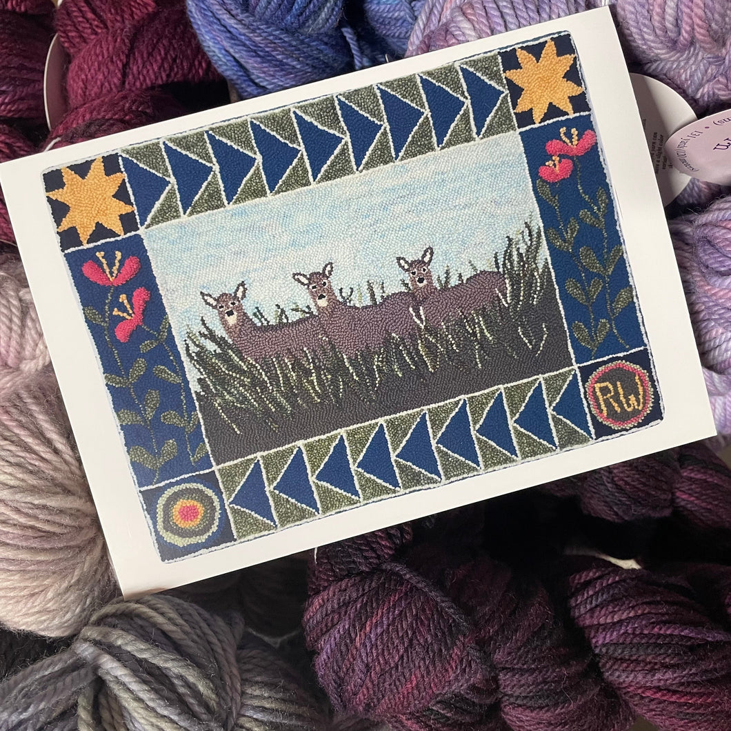 Card with a design of two deer in a field surrounded by yarn balls